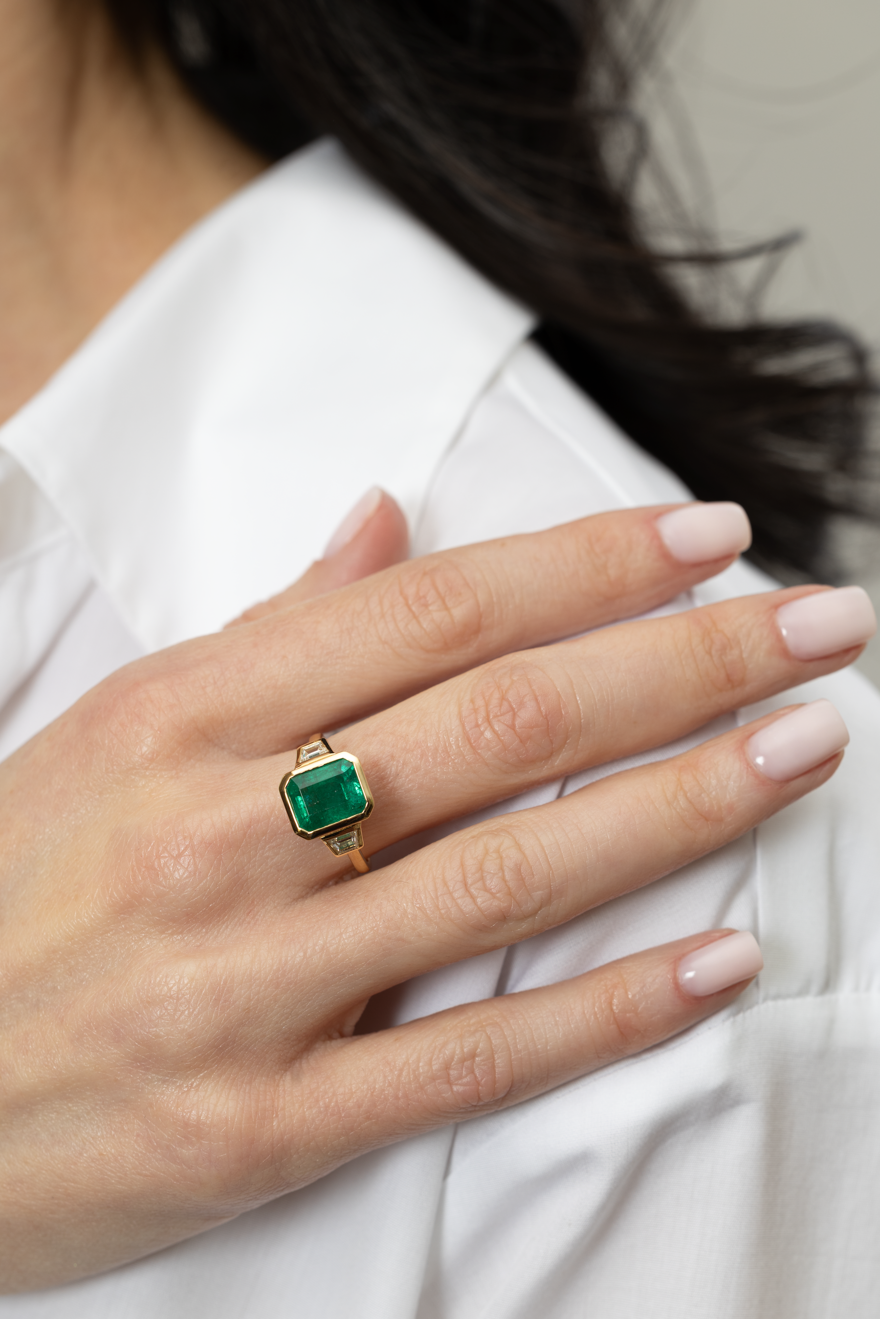 4.10 CARAT EMERALD AND DIAMOND THREE-STONE RING