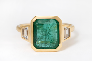 4.26 EMERALD AND DIAMOND THREE-STONE RING