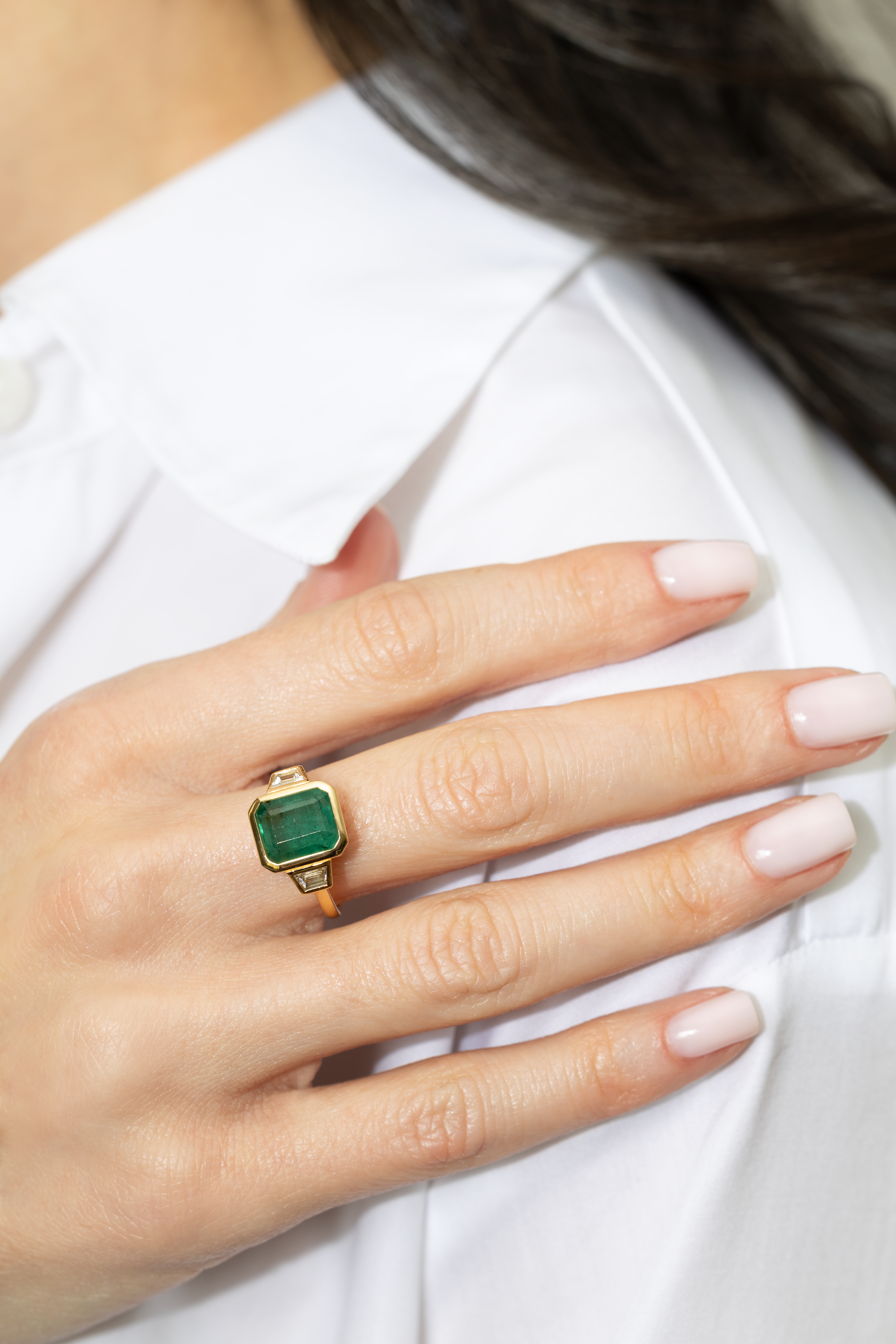 4.26 EMERALD AND DIAMOND THREE-STONE RING